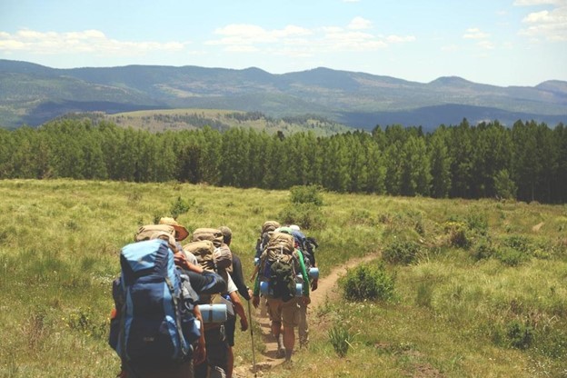 A group of friends taking a hike and viewing the scenery for a must-do Seattle summer activity.