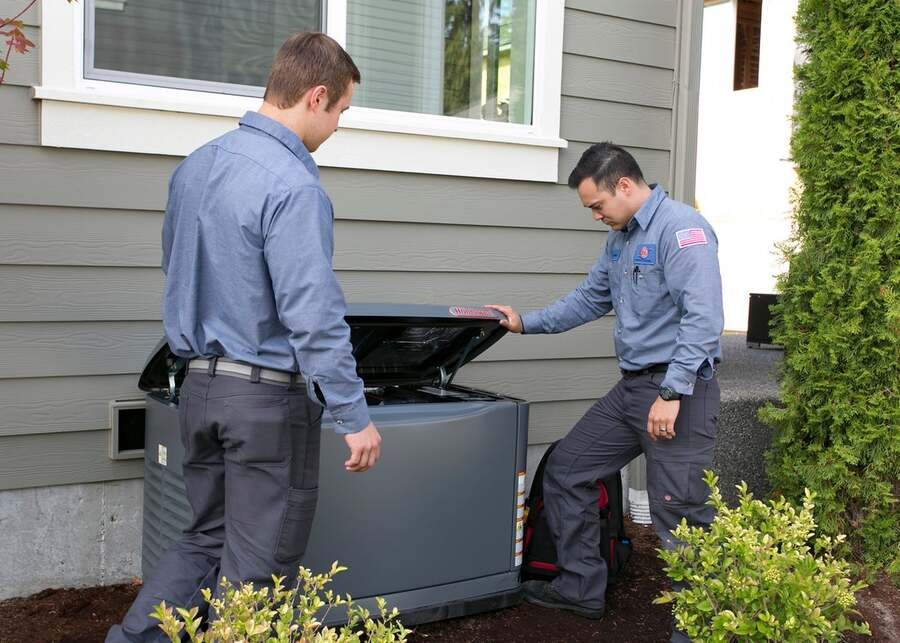 Two Bob’s Heating technicians check on an HVAC installation.