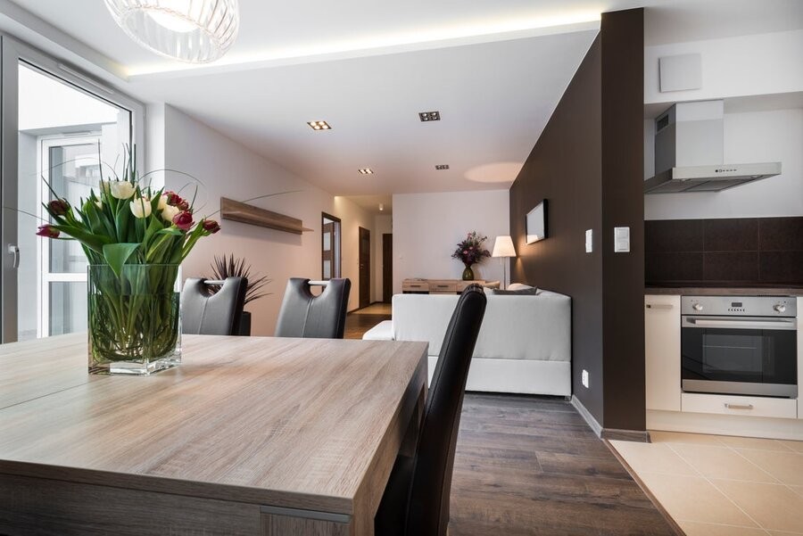 A modern kitchen space and diing room. 