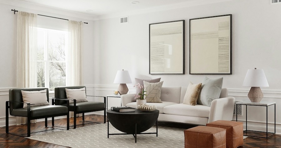 iving room with neutral color scheme shows trees through the window that are beginning to lose leaves in autumn.