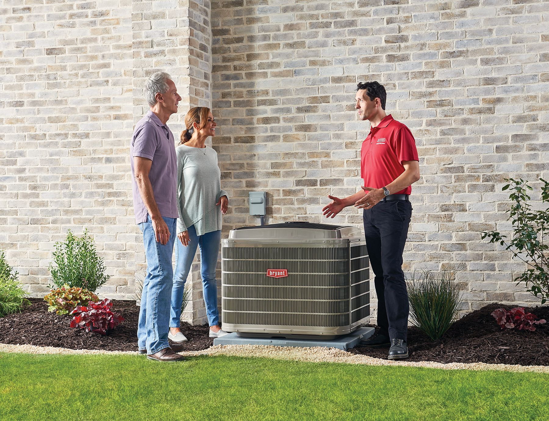 technician talking with homeowners outside