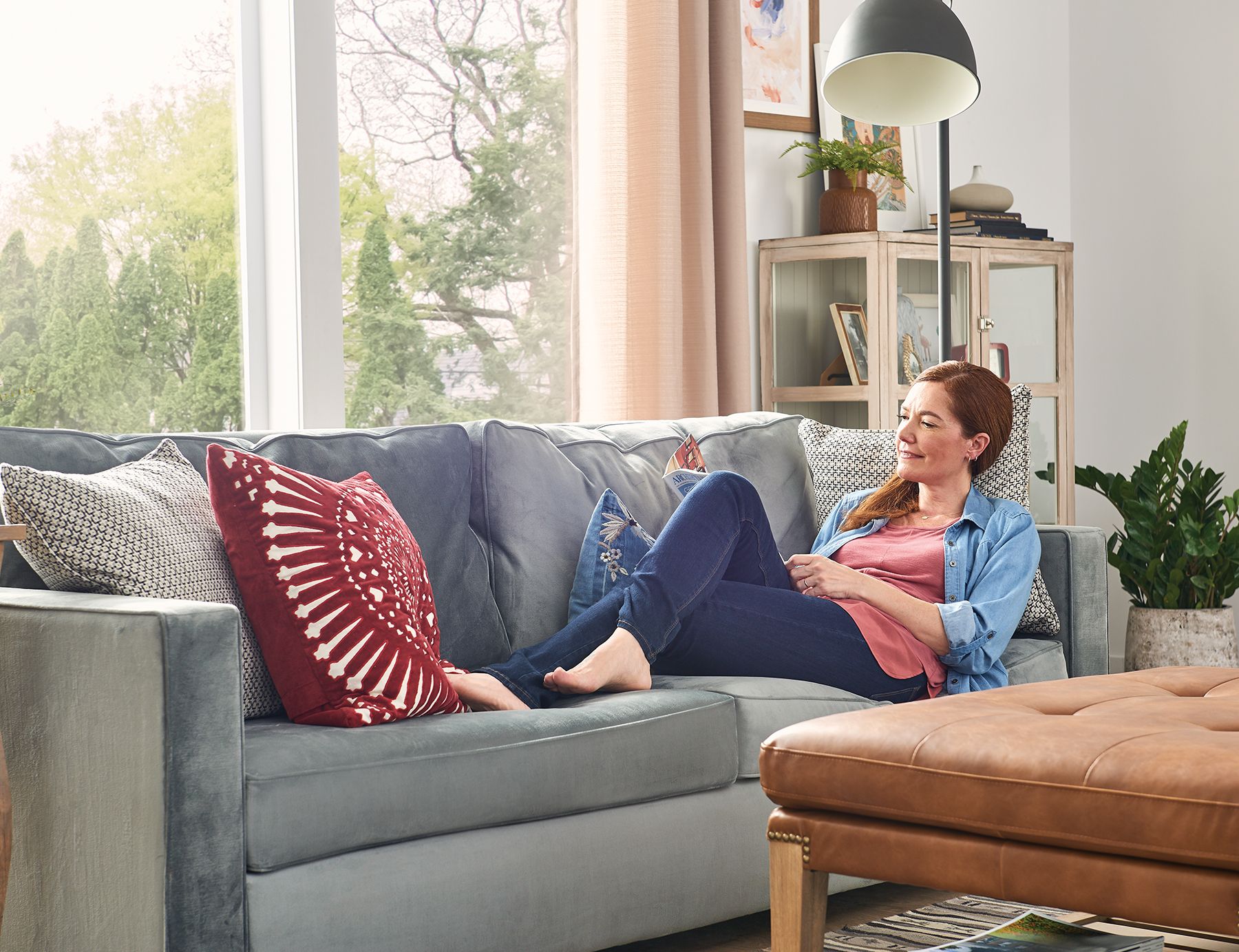 woman on couch near window