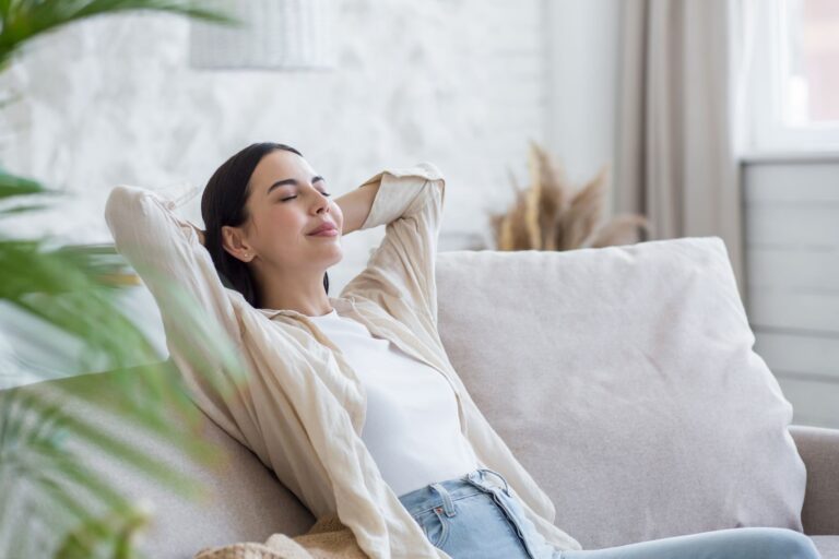 A woman relaxing on her sofa at home